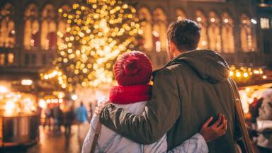 Photo of a young couple enjoy the decoration on Christmas Market, during Christmas Holidays