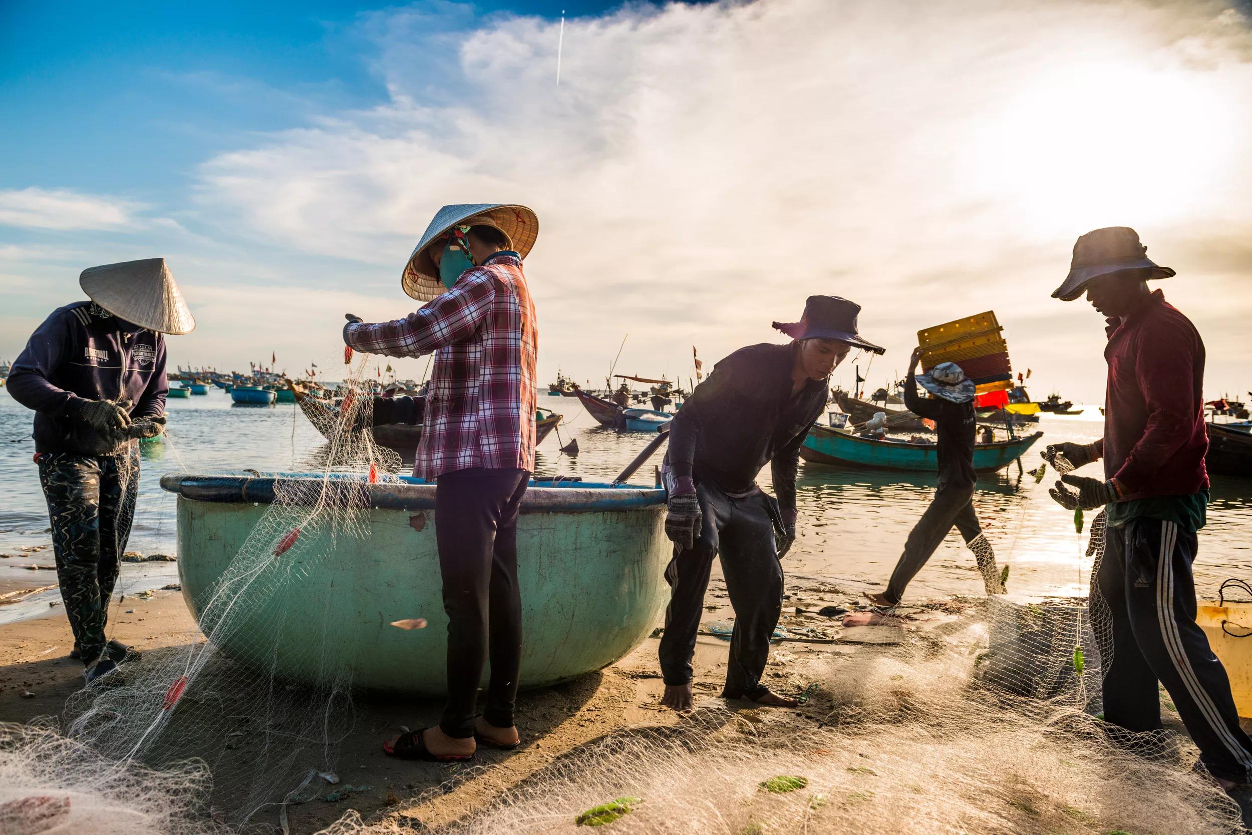 Phan Thiet, Vietnam, November 2016. Fishermen prepare for the catch of the day on the beach of Phan Thiet, which is the largest fish sauce producer of Vietnam. Phan Thiet is a quiet beach resort town on the South China sea. Vietnam is a popular Asian travel destination for tourists and travelers. Photo by Frits Meyst / MeystPhoto.com