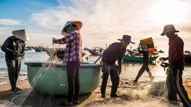 Phan Thiet, Vietnam, November 2016. Fishermen prepare for the catch of the day on the beach of Phan Thiet, which is the largest fish sauce producer of Vietnam. Phan Thiet is a quiet beach resort town on the South China sea. Vietnam is a popular Asian travel destination for tourists and travelers. Photo by Frits Meyst / MeystPhoto.com