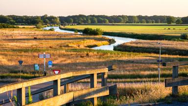 In the eastern Netherlands there is a valley of the river Vecht (Vechtdal in Dutch). The sun is setting at the valley near the village Marienberg. Photo is taken from a viewing point called Distelbelt
