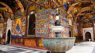 Frescoes painted on the exterior of the Rila Monastery in Bulgaria, an important pilgrimage spot for Bulgarian Orthodox Christians. The frescoes picture saints and also the rewards of Heaven along with the pains of Hell