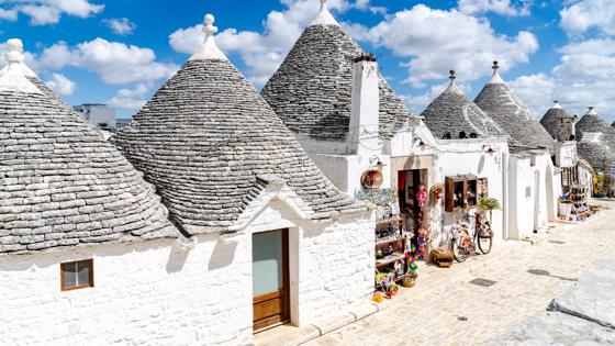 Traditional whitewashed Trulli houses in summer, Alberobello, province of Bari, Apulia, Italy