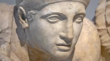 Ancient ruins of the Philippeion at Olympia, Greece. Detail of an ancient Greek statue of a human. Site of the ancient Olympic Games is situated on the Peloponnese. UNESCO world heritage site.