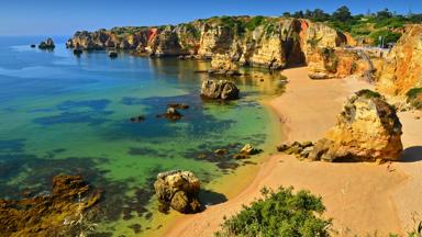 View from above of famous Dona Ana beach (praia dona ana), one of the most spectacular beaches in Lagos, Algarve, Portugal, with its golden cliffs, rocks on the sea and clear waters.