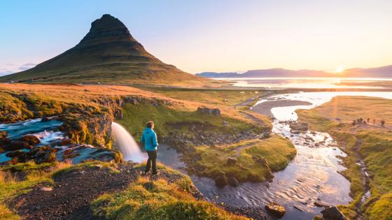 ijsland_noord_Kirkjufell_schiereiland_man_uitzicht_zon_GettyImages-1183240360