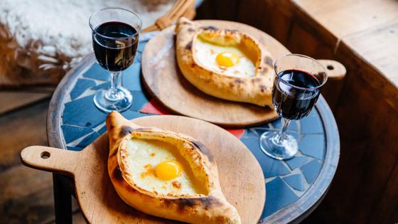 Traditional Georgian cuisine - Khachapuri (Adjarian style), pastry with cheese and egg