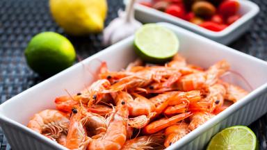 Fresh delicious prawns with lime on the plate