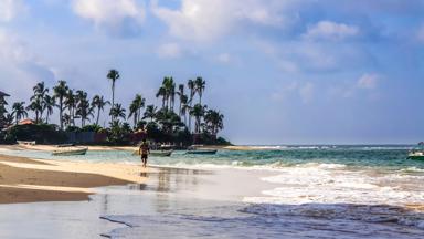 sri-lanka_beruwela_oceaan_strand_vissersbootjes_palmbomen_man_shutterstock_697308214