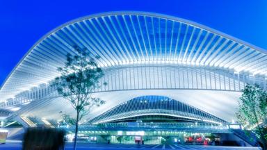 futuristic building of a railway station illuminated at night, Liege, Guillemins, Belgium