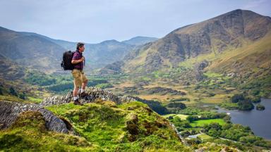 A walker at Glanmore Lake, Healy Pass, Kerry, Ireland