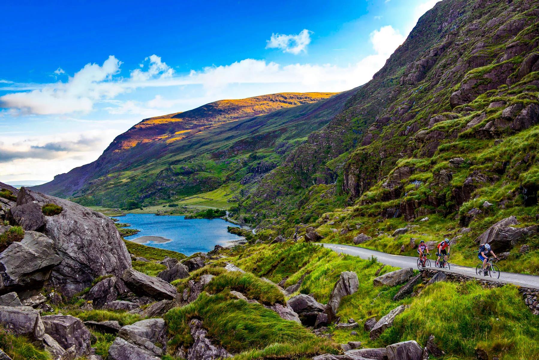 4 people on bicycles make their way up the Gap of Dunloe , Co. Kerry, Ireland
