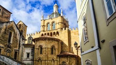 Exterior view of the old Romanesque cathedral, Coimbra, Portugal.