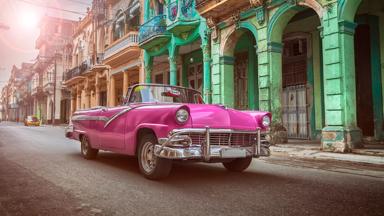 Vintage classic pink american oldtimer convertible in old town of Havana Cuba