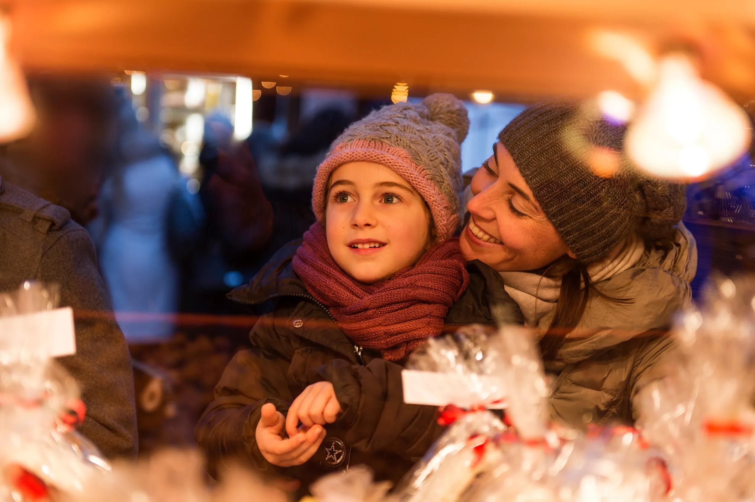 happy child at christmas market with sweet