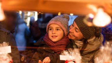 happy child at christmas market with sweet