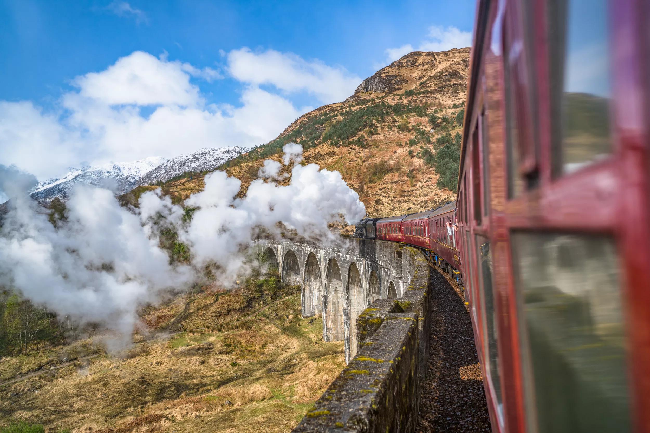 United Kingdom, Scotland, Highland, Glenfinnan, A830, Glenfinnan Viaduct, Steam train passing viaduct