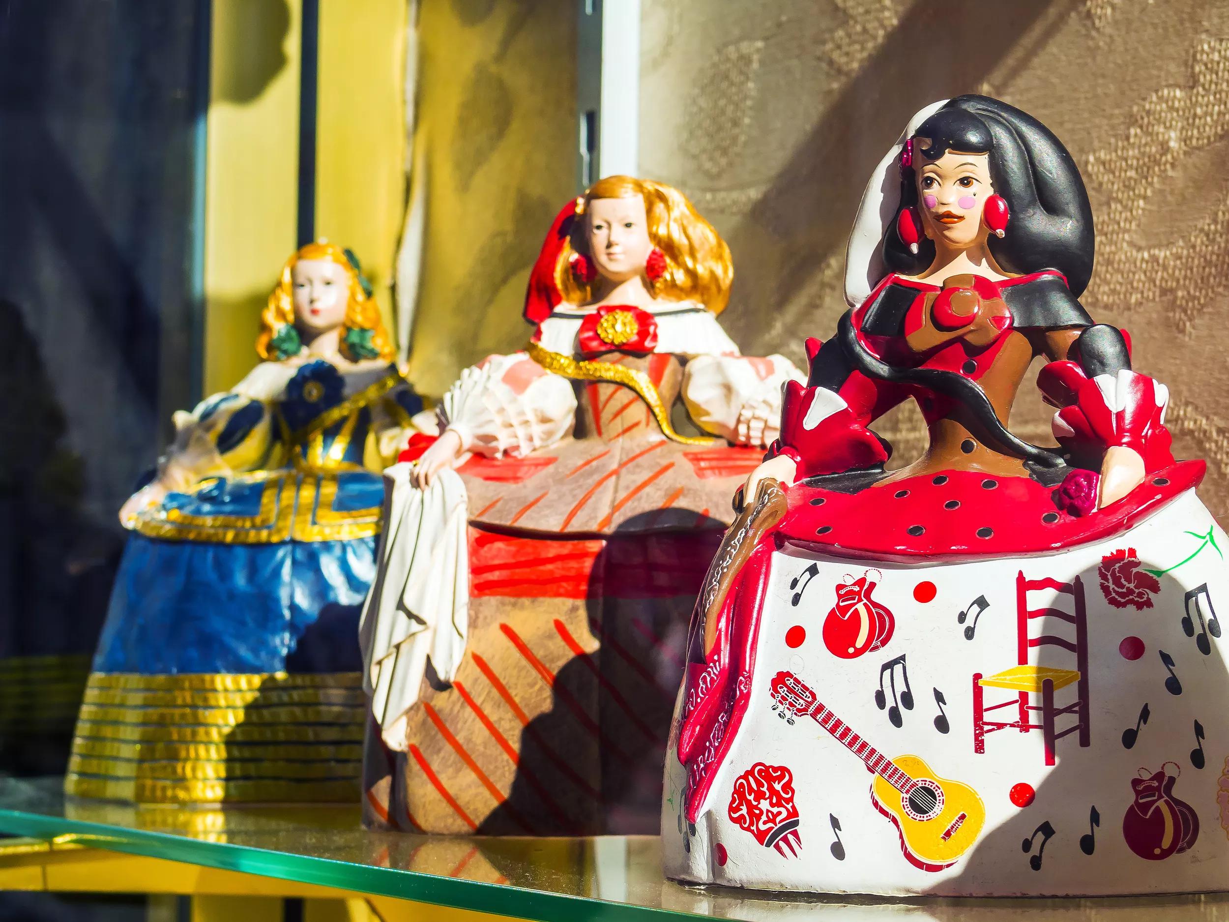 Spain, Madrid, El Rastro flea market..El Rastro is the most popular open air flea market in Spain and the biggest in Europe. It is held every Sunday and public holiday during the year and is located between Calle Embajadores and the Ronda de Toledo...There are many stalls where it is possible to hunt bargains, old items and antiquities...This image shows a Meninas that means "little girl" in Spanish..They are very popular because the famous painter Velázquez and his most famous painting known as Las Meninas.