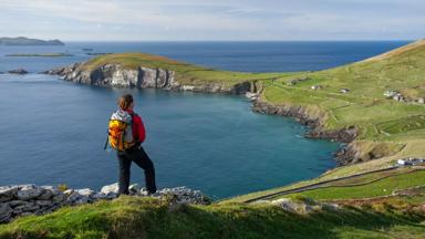 Walker on the Dingle Way above Slea Head, Dingle Peninsula, County Kerry, Ireland.