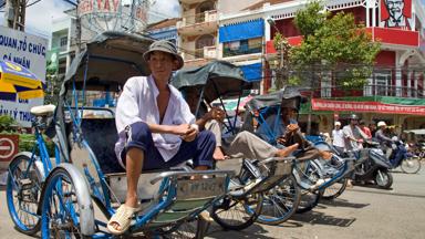 Ho Chi Minh City, Vietnam, October 2008. Cyclo taxi's wait for a fare in front of he Chinese Bin Tay wholesale market and the KFC, kentucky Fried Chicken in Cholon.  Photo by Frits Meyst/Adventure4ever.com